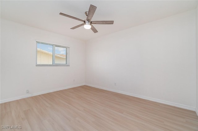 spare room featuring light hardwood / wood-style floors and ceiling fan