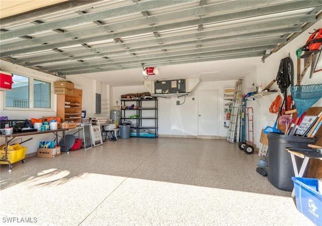 garage with a garage door opener and electric panel