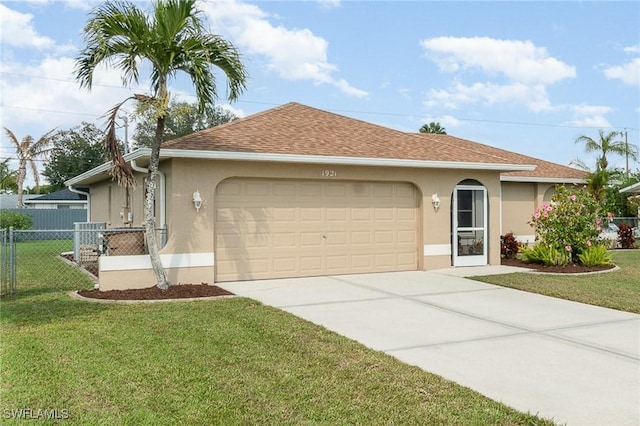 ranch-style house featuring a garage and a front lawn