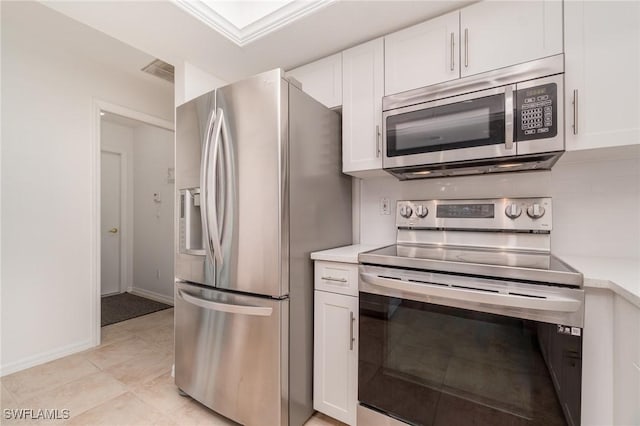 kitchen featuring white cabinetry, appliances with stainless steel finishes, and light tile patterned floors