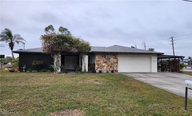 ranch-style house featuring a garage, a carport, and a front lawn