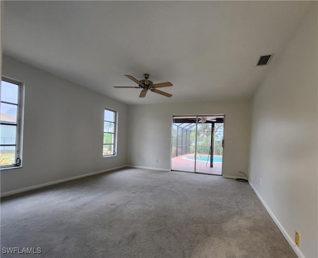 empty room featuring ceiling fan and carpet flooring