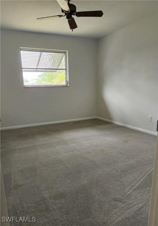 empty room with carpet and ceiling fan