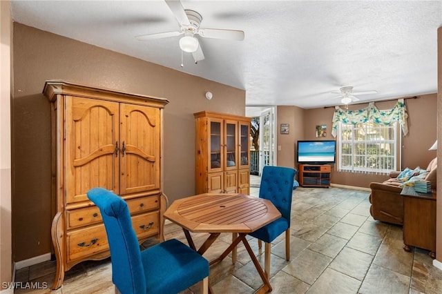 dining area featuring a textured ceiling and ceiling fan