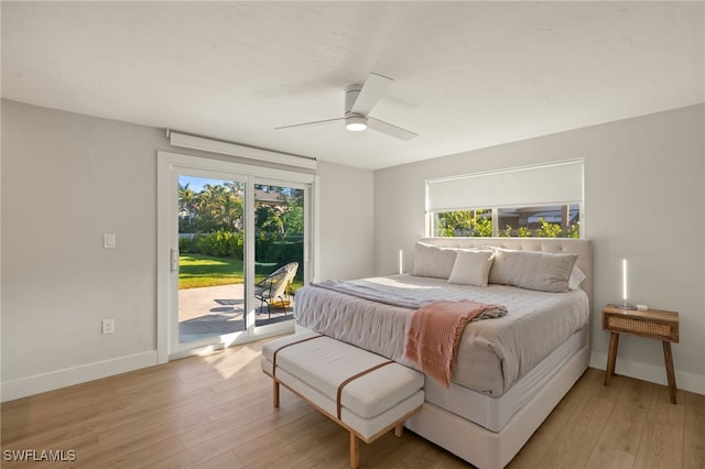 bedroom featuring multiple windows, access to exterior, ceiling fan, and light hardwood / wood-style flooring