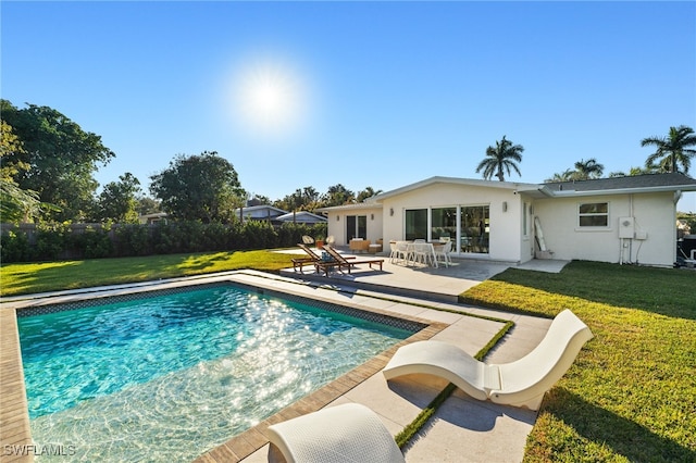 view of swimming pool featuring a patio area and a lawn