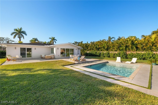 back of house featuring a fenced in pool, a patio area, and a lawn