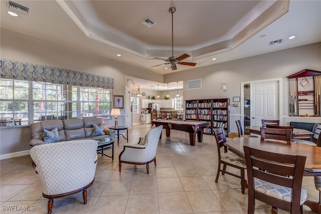 living room with light tile patterned floors, visible vents, and a raised ceiling