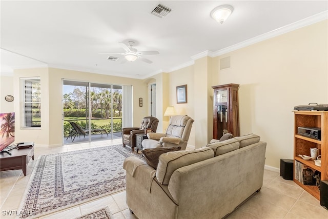 living room with light tile patterned floors, baseboards, visible vents, ceiling fan, and crown molding