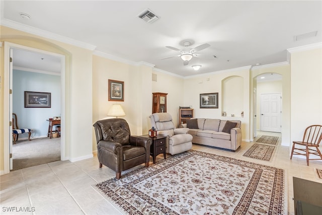 living room with ornamental molding, arched walkways, light tile patterned flooring, and visible vents