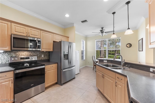 kitchen with stainless steel appliances, light brown cabinetry, and a sink