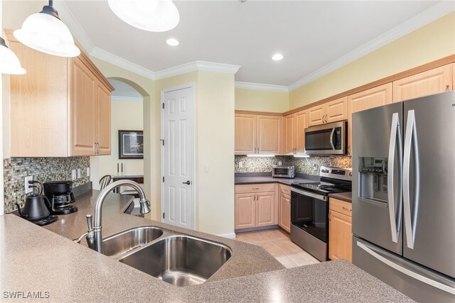 kitchen with stainless steel appliances, light brown cabinets, a sink, and crown molding