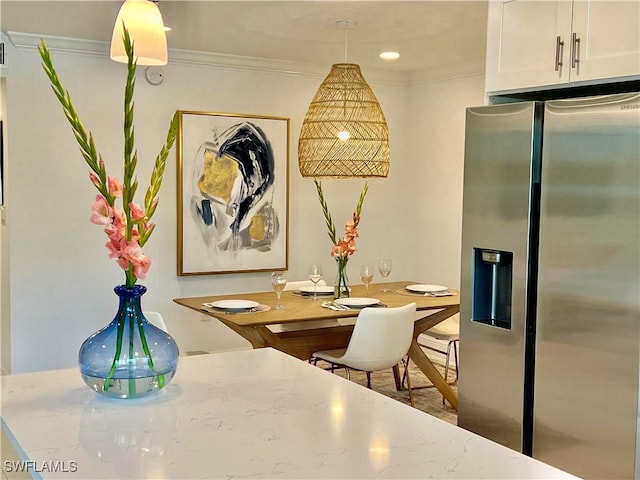 dining space featuring crown molding