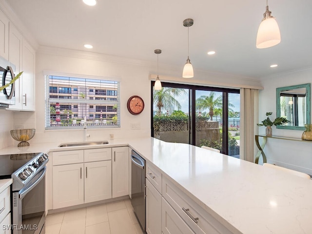 kitchen with white cabinetry, appliances with stainless steel finishes, decorative light fixtures, and sink