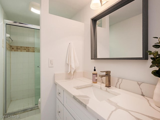 bathroom with vanity, toilet, and an enclosed shower