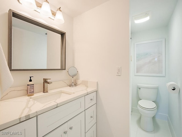 bathroom featuring tile patterned flooring, vanity, and toilet