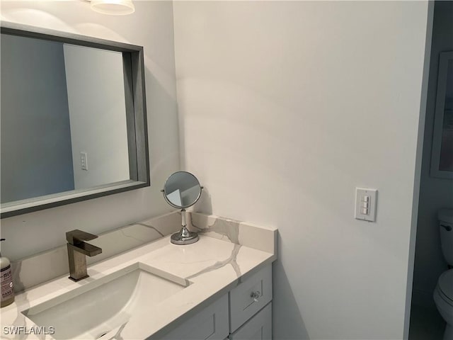 bathroom with vanity and toilet