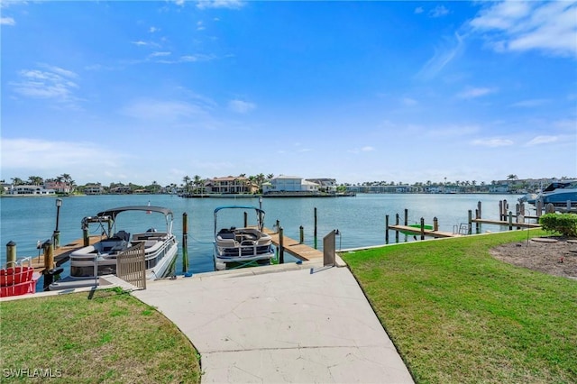 dock area featuring a water view and a lawn