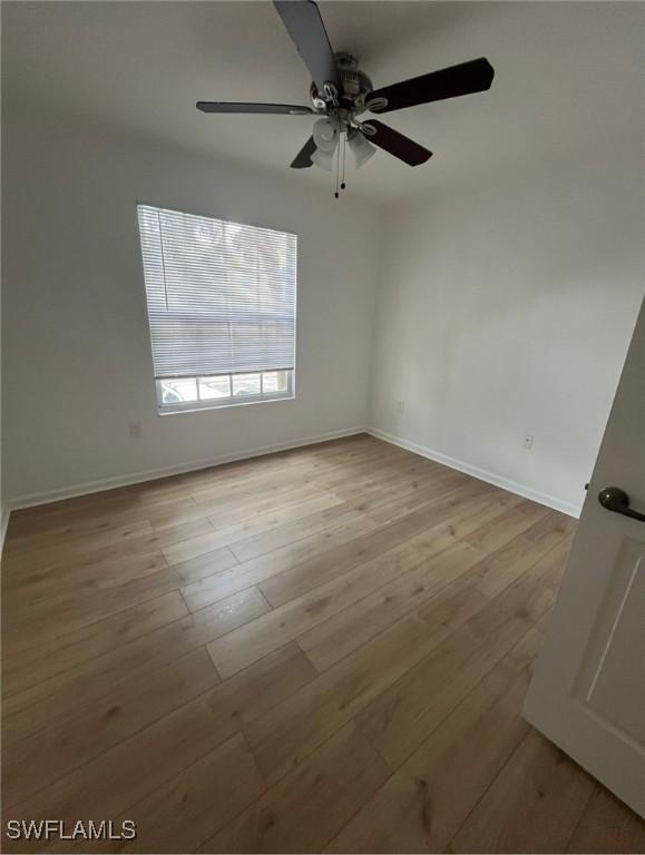 unfurnished room featuring light hardwood / wood-style floors and ceiling fan