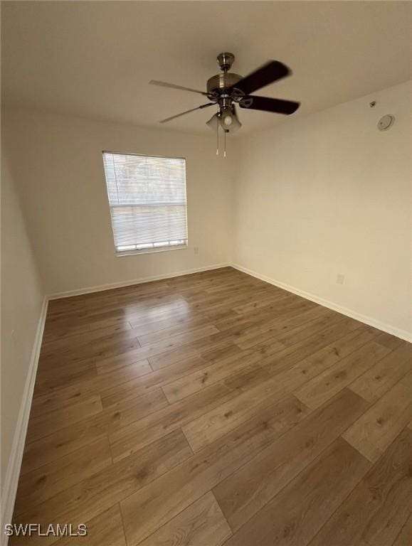 unfurnished room with wood-type flooring and ceiling fan