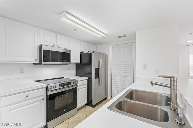 kitchen featuring a sink, stainless steel appliances, visible vents, and white cabinetry