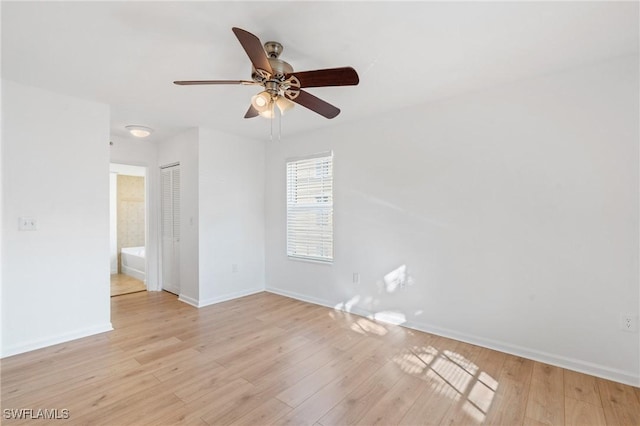 empty room with a ceiling fan, baseboards, and light wood-type flooring