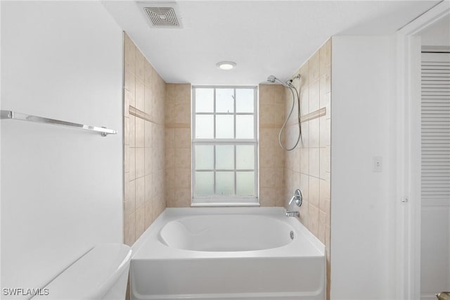 bathroom featuring visible vents, toilet, and bathtub / shower combination