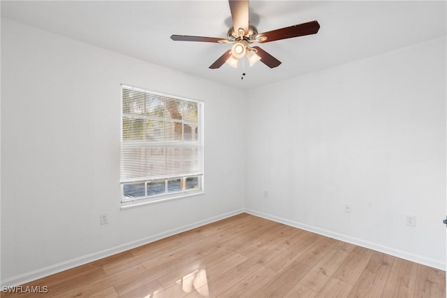 unfurnished room featuring baseboards, light wood-type flooring, and ceiling fan