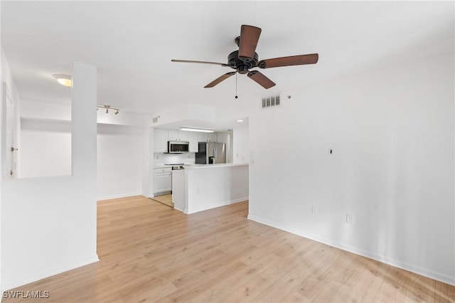 unfurnished living room with baseboards, visible vents, light wood finished floors, and ceiling fan