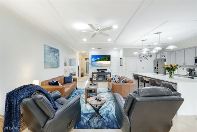 living room with crown molding, ceiling fan with notable chandelier, and light tile patterned floors