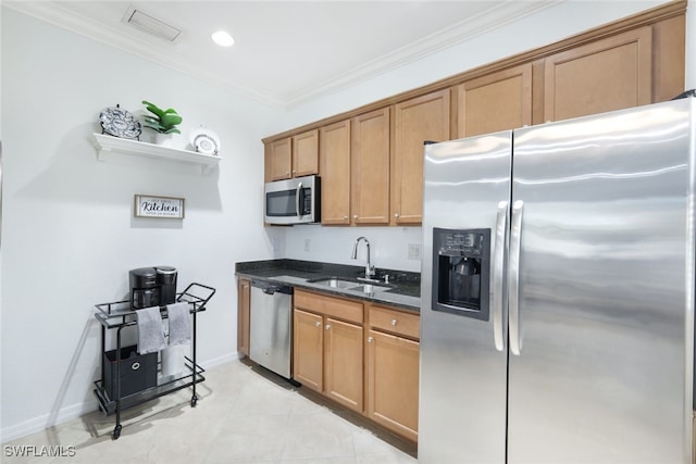 kitchen featuring appliances with stainless steel finishes, sink, dark stone countertops, light tile patterned floors, and crown molding