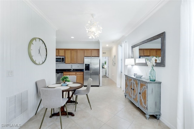 dining space featuring ornamental molding and a notable chandelier