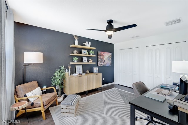 home office with wood-type flooring and ceiling fan