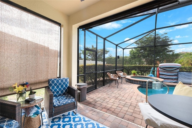 view of patio / terrace with an in ground hot tub and a lanai