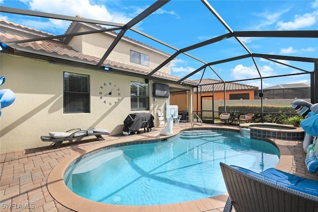 view of pool with an in ground hot tub, a lanai, and a patio