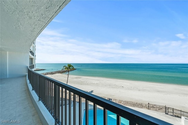 balcony with a beach view and a water view