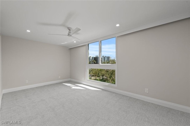 carpeted empty room featuring ceiling fan