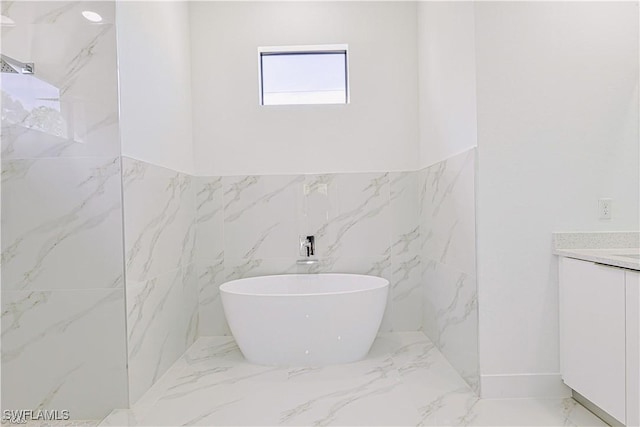 bathroom with vanity and a tub to relax in