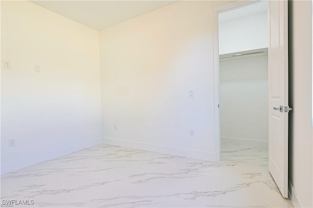 unfurnished bedroom with a spacious closet and a closet