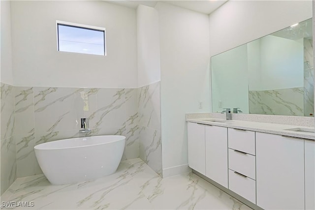 bathroom featuring vanity and a tub to relax in