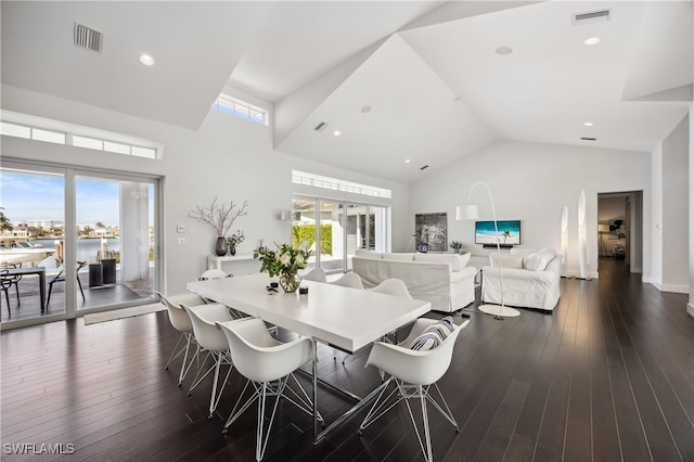 dining area featuring dark hardwood / wood-style flooring, high vaulted ceiling, and a wealth of natural light