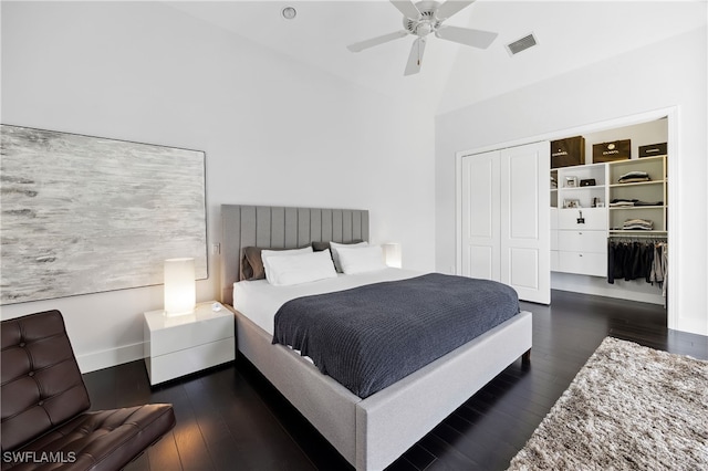 bedroom featuring ceiling fan, dark hardwood / wood-style floors, vaulted ceiling, and a closet