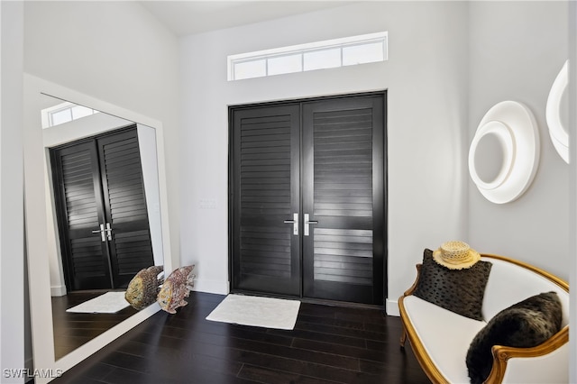 foyer entrance with dark wood-type flooring and french doors