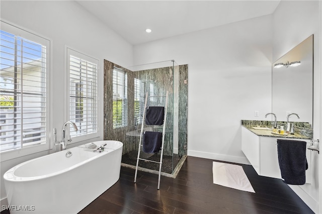 bathroom with vanity, hardwood / wood-style floors, and shower with separate bathtub