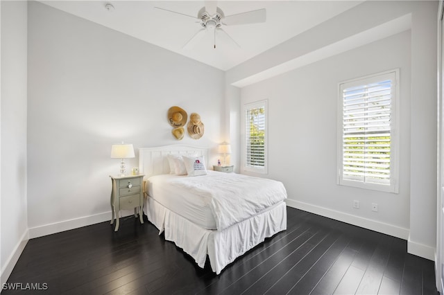 bedroom with ceiling fan and dark hardwood / wood-style flooring