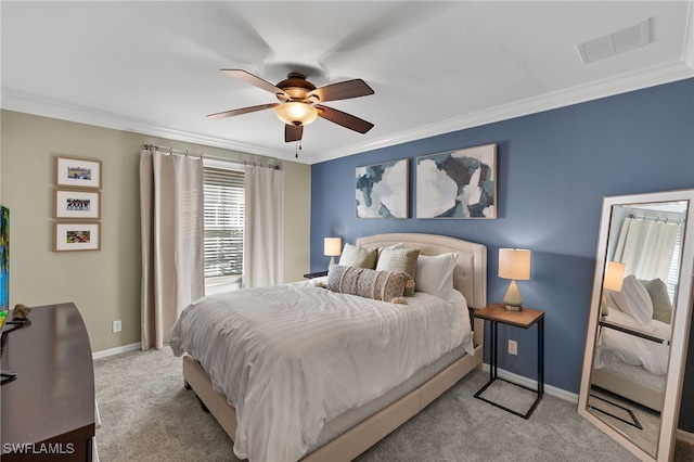 bedroom featuring ornamental molding, light colored carpet, and ceiling fan