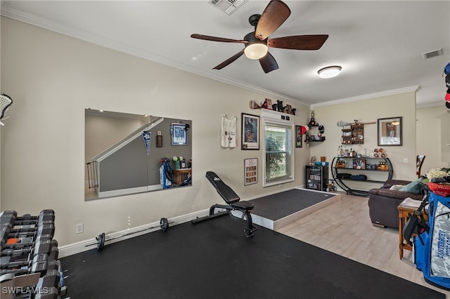 exercise area with ceiling fan, ornamental molding, and light wood-type flooring