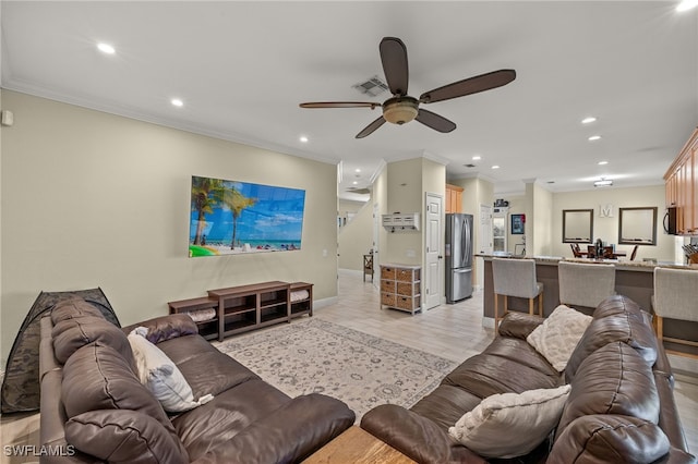 living room featuring crown molding, ceiling fan, and light hardwood / wood-style flooring