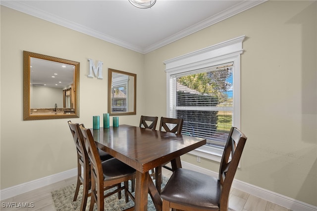 dining area with sink and crown molding