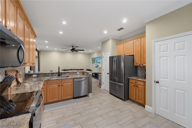 kitchen with sink, light stone counters, crown molding, stainless steel appliances, and decorative backsplash